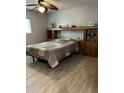Bedroom with a wood-trimmed headboard, built-in cabinets, and drawers at 5303 W Port Au Prince Ln, Glendale, AZ 85306