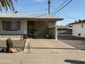 Inviting home exterior with covered parking, xeriscaping, and charming architectural details at 5517 E Boise St, Mesa, AZ 85205