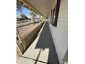 A side view of a covered front porch with decorative railing, adding charm to the home's entry at 5517 E Boise St, Mesa, AZ 85205