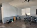 Cozy living room with wood-look flooring, neutral walls, and abundant natural light at 5735 E Mcdowell Rd # 63, Mesa, AZ 85215