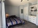 Comfortable bedroom with built-in storage, soft lighting, and calming neutral tones at 5735 E Mcdowell Rd # 63, Mesa, AZ 85215