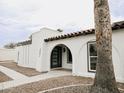 Inviting front entrance with an arched doorway, modern door, and desert landscaping at 6401 E Eugie Ter, Scottsdale, AZ 85254