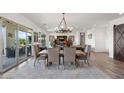 Bright dining area featuring a chandelier, rug, and view to patio at 11249 N Blakely St, Surprise, AZ 85388