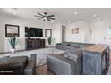 Spacious living room with ceiling fan, television and view of dining area at 11249 N Blakely St, Surprise, AZ 85388