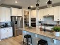Modern kitchen with granite counters, stainless steel appliances and black hardware at 11403 W Ashby Dr, Peoria, AZ 85383