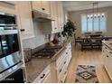 Modern kitchen with granite countertops, stainless appliances, and gas range at 11403 W Ashby Dr, Peoria, AZ 85383