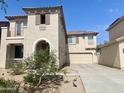 Two-story home shows a front yard with desert landscaping and a driveway leading to the attached two-car garage at 11906 N 154Th N Ln, Surprise, AZ 85379