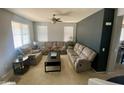 Neutral-colored living room with large windows and plush, comfortable seating, creating a cozy gathering space at 11906 N 154Th N Ln, Surprise, AZ 85379