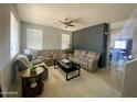 Spacious living room boasts a ceiling fan, large windows, and comfortable seating, offering plenty of space at 11906 N 154Th N Ln, Surprise, AZ 85379