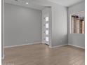 Cozy bedroom featuring tile flooring, a large window, and a modern door at 12332 W Parkway Ln, Avondale, AZ 85323