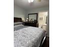Bedroom with a large mirror and attached bathroom at 14922 W Port Au Prince Ln, Surprise, AZ 85374