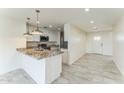 Well-lit kitchen featuring granite countertops, stainless steel appliances, and an island at 15120 S Amado Blvd, Arizona City, AZ 85123