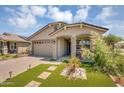 Inviting single-story home with a two-car garage, desert landscaping, and a charming front porch at 15133 W Moreland St, Goodyear, AZ 85338
