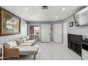 Bright living room with tile floors, a neutral-toned sofa, and a fireplace, offering a cozy and inviting space at 20250 N 6Th Dr # 3, Phoenix, AZ 85027