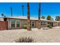 This home has desert landscaping with lush bushes in the front yard with palm trees at 2062 S Emerson --, Mesa, AZ 85210