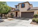 Inviting two-story home with covered porch, two-car garage, and well-maintained landscaping at 2096 S Moccasin Trl, Gilbert, AZ 85295