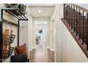 Welcoming hallway with hardwood floors, staircase, and views into the home's dining area at 2096 S Moccasin Trl, Gilbert, AZ 85295
