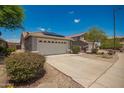 Single-story home with a two-car garage and low-maintenance desert landscaping at 25732 W Elizabeth Ave, Buckeye, AZ 85326