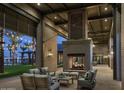 Inviting outdoor living space with a fireplace is perfect for gatherings and enjoying the evening ambiance at 26420 N 24Th Gln, Phoenix, AZ 85085