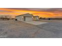 Side view of this single-story home shows the modern design, oversized garage, and desert landscape at 28834 N 175Th Ave, Surprise, AZ 85387
