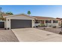 Well-kept home features a two-car garage, low-maintenance desert landscaping, and a neutral color scheme at 3010 E Yucca St, Phoenix, AZ 85028