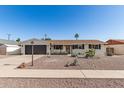 Inviting single-story home showcasing desert landscaping and a well-maintained exterior under a clear sky at 3010 E Yucca St, Phoenix, AZ 85028