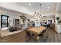 Open-concept home featuring a dining area with a rustic table and views into the living room and kitchen at 33667 N 71St Way, Scottsdale, AZ 85266