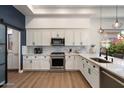 Bright kitchen with white cabinets, quartz countertops, and stainless steel appliances and modern features at 33667 N 71St Way, Scottsdale, AZ 85266