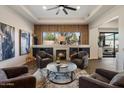 Cozy sitting room with a fireplace, plush chairs, and modern artwork and accents at 33667 N 71St Way, Scottsdale, AZ 85266