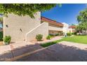 Condo community featuring tan stucco exterior, balcony and well-manicured green spaces at 3828 N 32Nd St # 213, Phoenix, AZ 85018