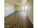 Bright living room featuring modern wood flooring and natural light from a window at 3828 N 32Nd St # 213, Phoenix, AZ 85018