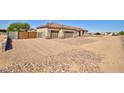 Inviting single-story home featuring a three-car garage, block perimeter fence and low maintenance landscape at 3850 N Mateo Dr, Eloy, AZ 85131