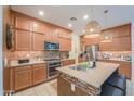 Spacious kitchen with granite countertops, stainless steel appliances, and warm wooden cabinetry at 3855 S Mcqueen Rd # 12, Chandler, AZ 85286