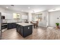 Stylish kitchen with a center island, modern appliances, and a dining area at 3875 E Claxton Ave, Gilbert, AZ 85297