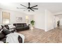 Spacious living room with a large leather sectional, wood-look floors, and neutral walls at 3875 E Claxton Ave, Gilbert, AZ 85297