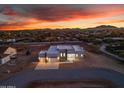 Panoramic aerial view showcasing modern home with clean lines, set against a vibrant sunset backdrop at 475 W Saddle Mountain Rd, Phoenix, AZ 85086