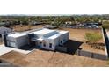 Modern-style home showcasing a pristine white exterior and minimalist design with many windows at 475 W Saddle Mountain Rd, Phoenix, AZ 85086