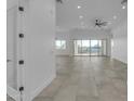 Expansive open-concept living space with modern tile flooring, recessed lighting, and abundant natural light at 475 W Saddle Mountain Rd, Phoenix, AZ 85086