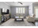 Comfortable living room with a neutral color scheme, large window with shutters, and contemporary decor at 5345 E Van Buren St # 209, Phoenix, AZ 85008