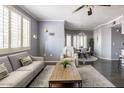 Cozy living room features a neutral palette with plush seating, plantation shutters, and dark hardwood floors at 5345 E Van Buren St # 209, Phoenix, AZ 85008
