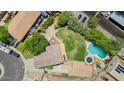 Sprawling property featuring a sparkling pool, lush green lawn, mature trees, and ample parking at 5787 W Barbara Ave, Glendale, AZ 85302