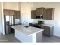 Modern kitchen featuring stainless steel appliances, an island, and stylish cabinetry at 5937 N Nigal Rd, Casa Grande, AZ 85194