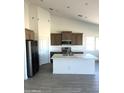 Modern kitchen featuring stainless steel appliances, an island, and stylish cabinetry at 5937 N Nigal Rd, Casa Grande, AZ 85194