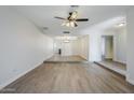 Open-concept living space featuring hardwood floors, a ceiling fan, recessed lighting, and an adjacent room at 6214 W Sunnyside Dr, Glendale, AZ 85304