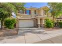 Charming two-story home featuring a neutral color scheme, tile roof, and a well-maintained front yard with mature trees at 6337 W Valencia Dr, Laveen, AZ 85339