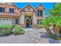 Welcoming home exterior featuring desert landscaping, a covered entryway, and a decorative front door at 6928 W Oraibi Dr, Glendale, AZ 85308