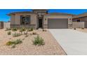 Charming single-story home with desert landscaping, gray trim, and a two-car garage at 6952 E Brushy Bill Rd, San Tan Valley, AZ 85143