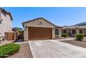 Single-story home featuring a two-car garage, desert landscaping, and a neutral color palette at 7086 W Spur Dr, Peoria, AZ 85383