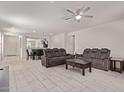 Open concept living room and dining area with tile floors, ceiling fan, and recessed lighting at 7086 W Spur Dr, Peoria, AZ 85383