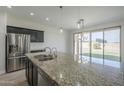 Kitchen island with granite countertops and stainless steel appliances at 8518 S 8Th Ln, Phoenix, AZ 85041